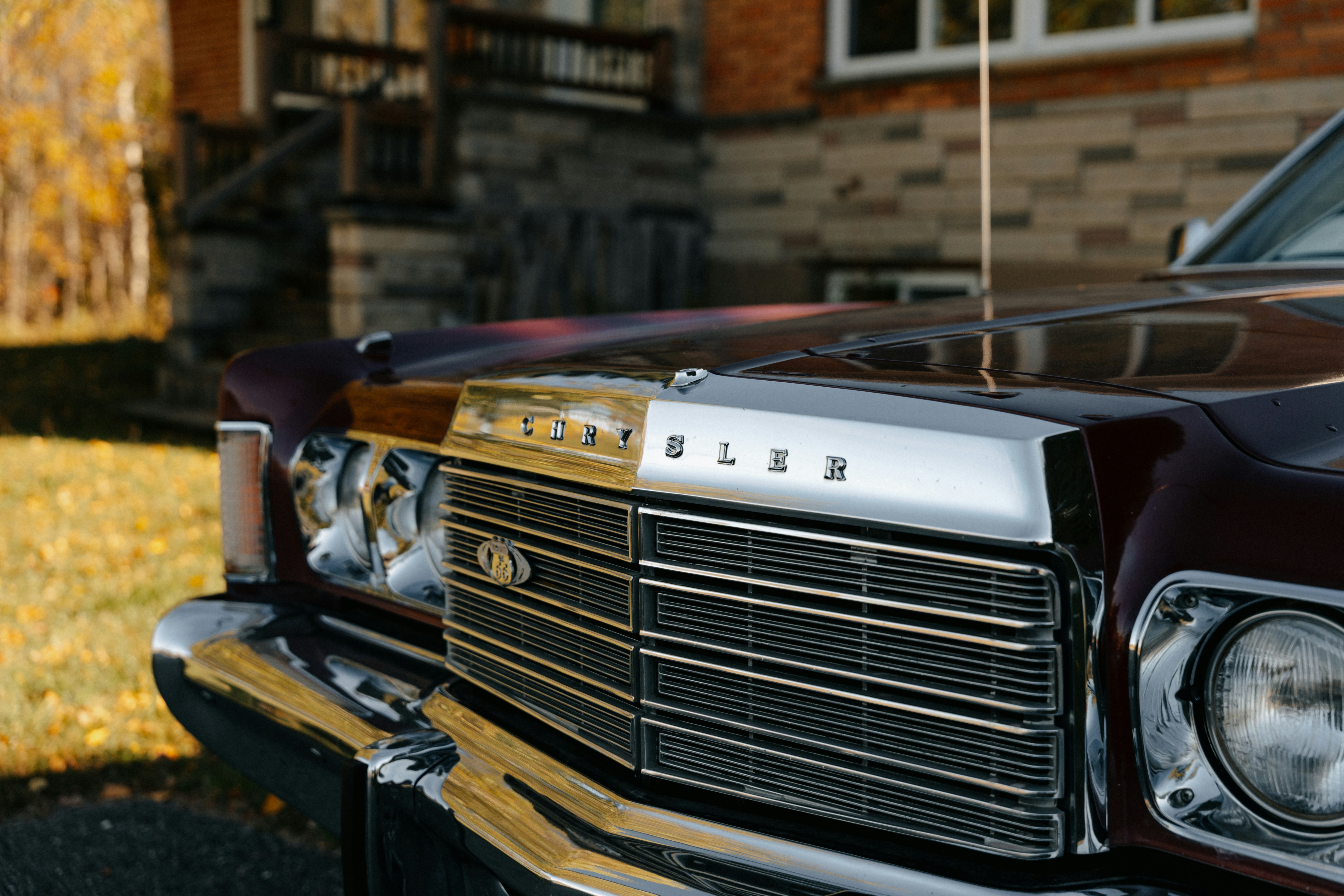 Maroon vintage chrysler car grille and hood detail