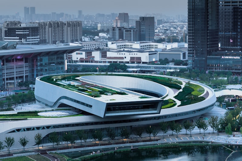 Modern building with a green rooftop and city skyline
