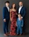 Family of four dressed formally posing for a portrait