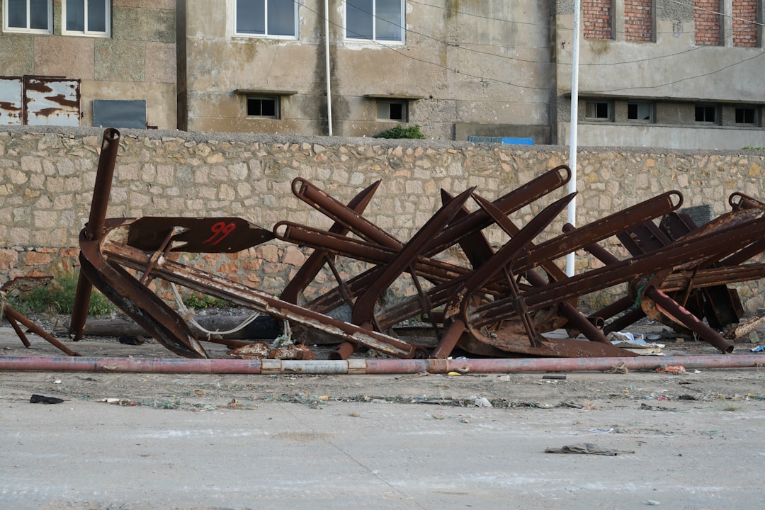 Pile of rusty ship anchors on the ground
