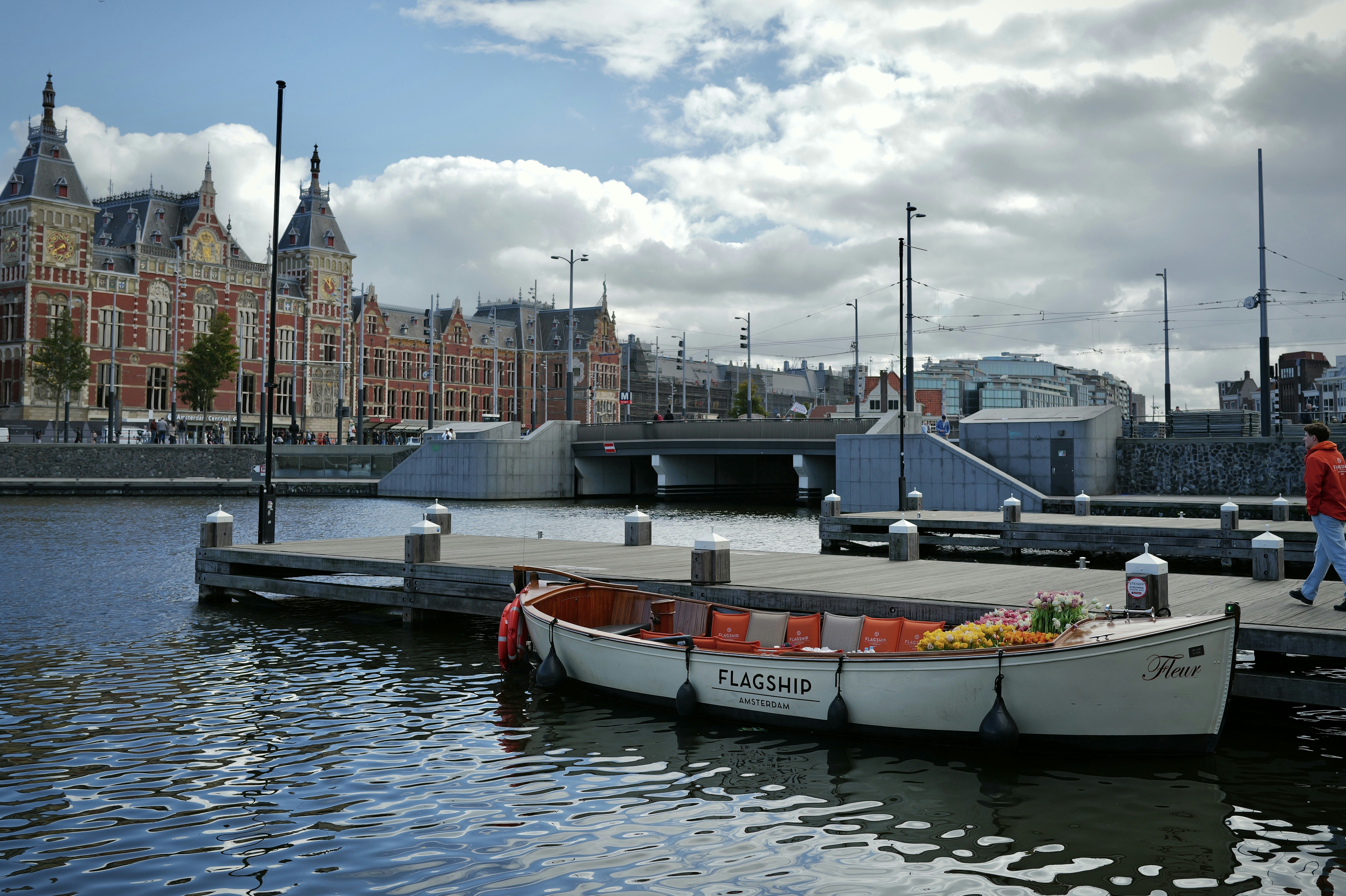 Boat docked on canal with historic building background