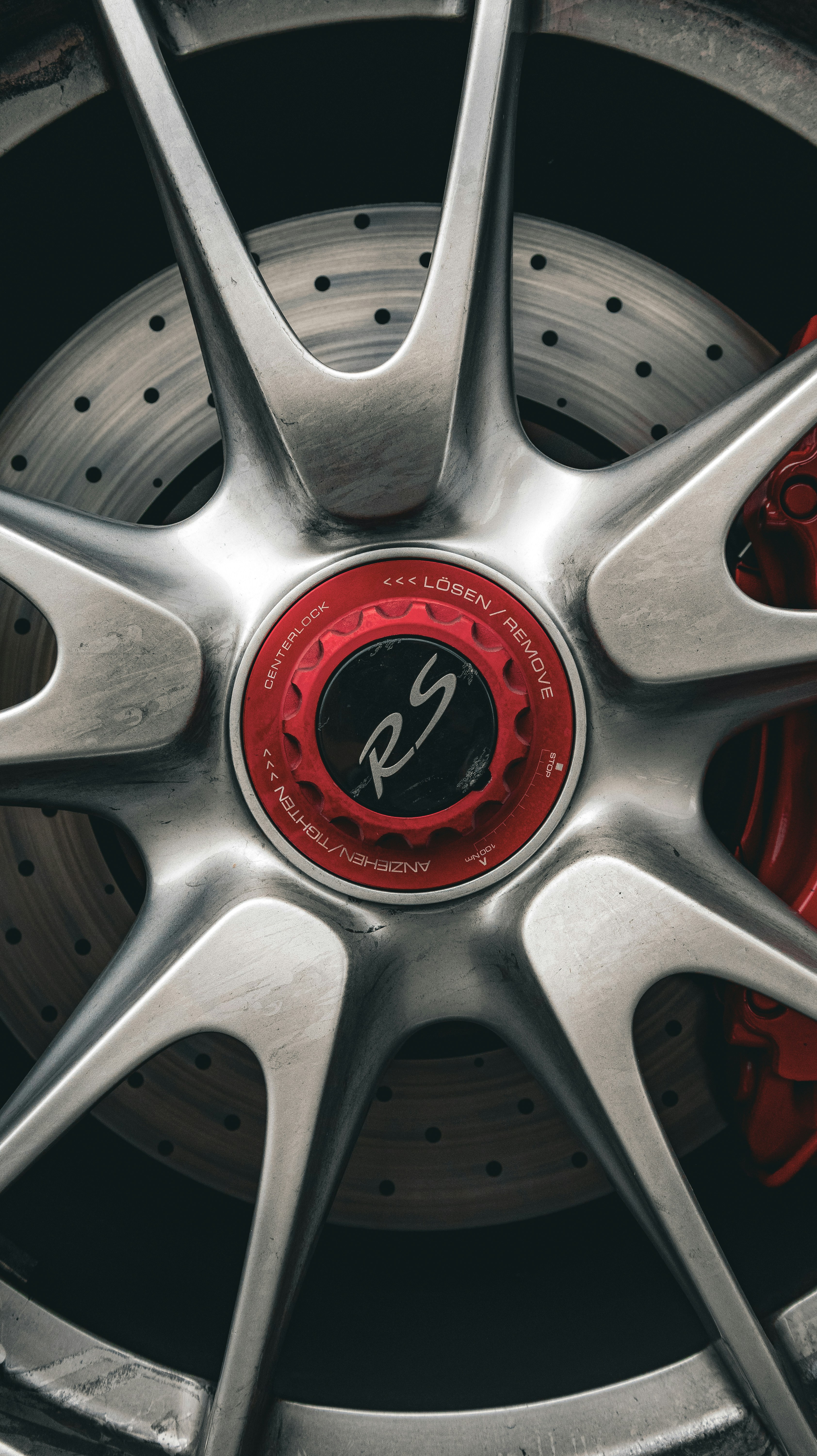 Close-up of a silver car wheel with red accents