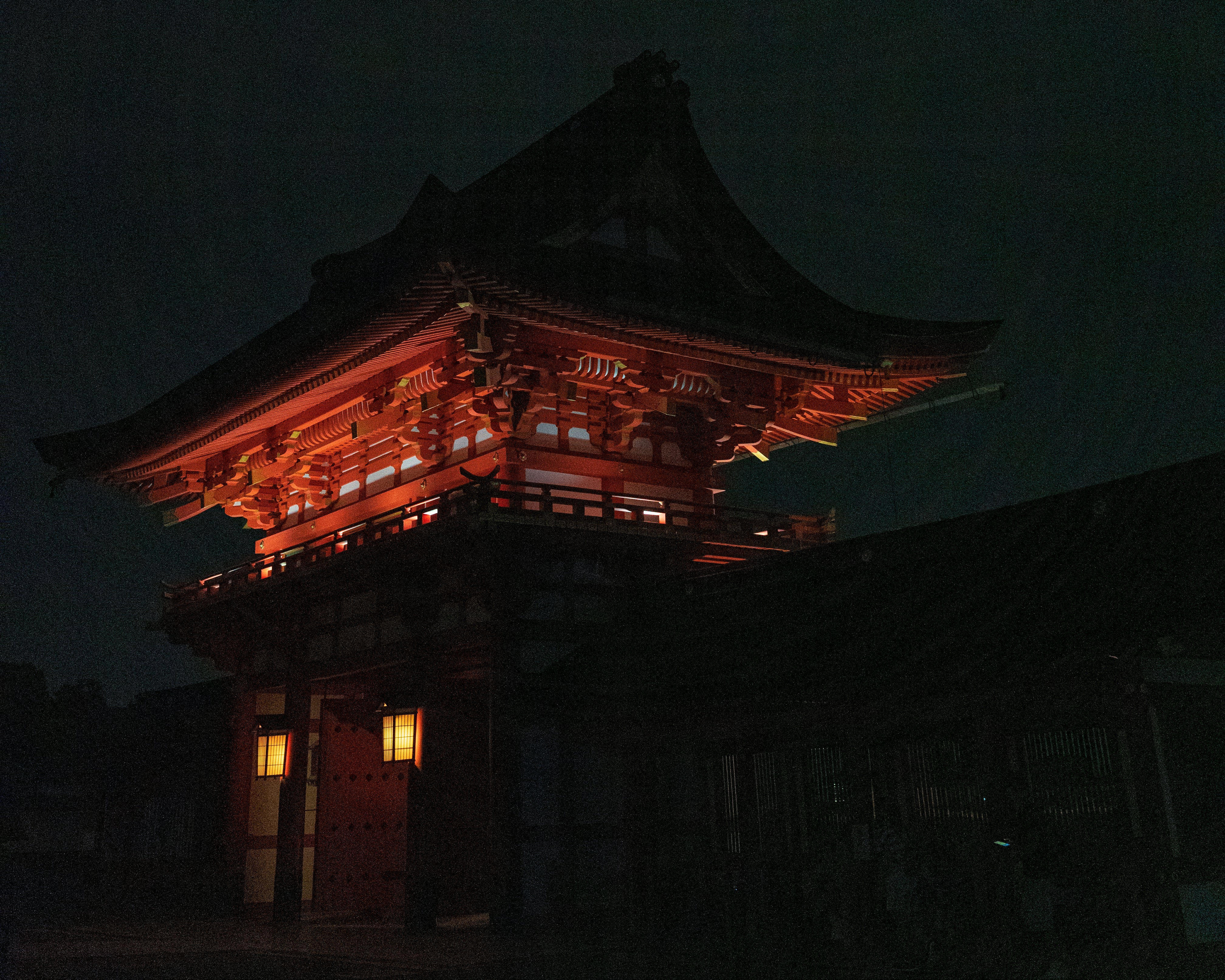 Ornate japanese temple illuminated at night