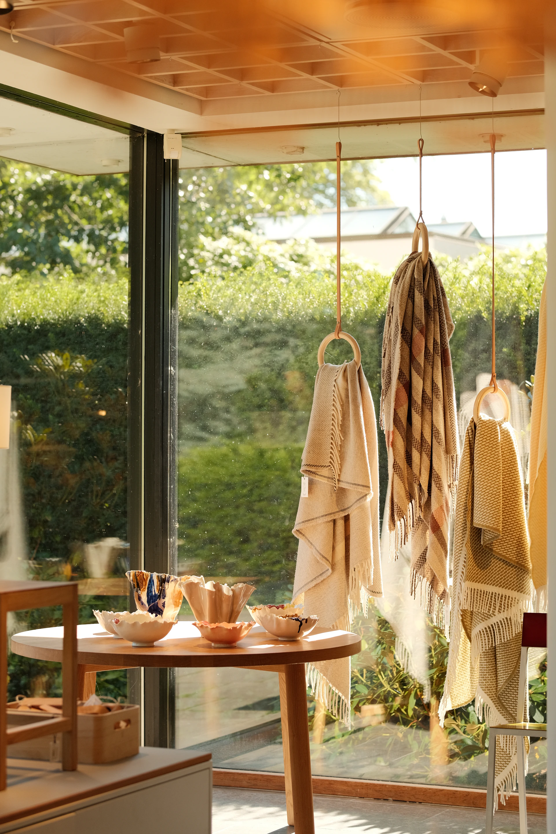 Textiles and bowls displayed near a window