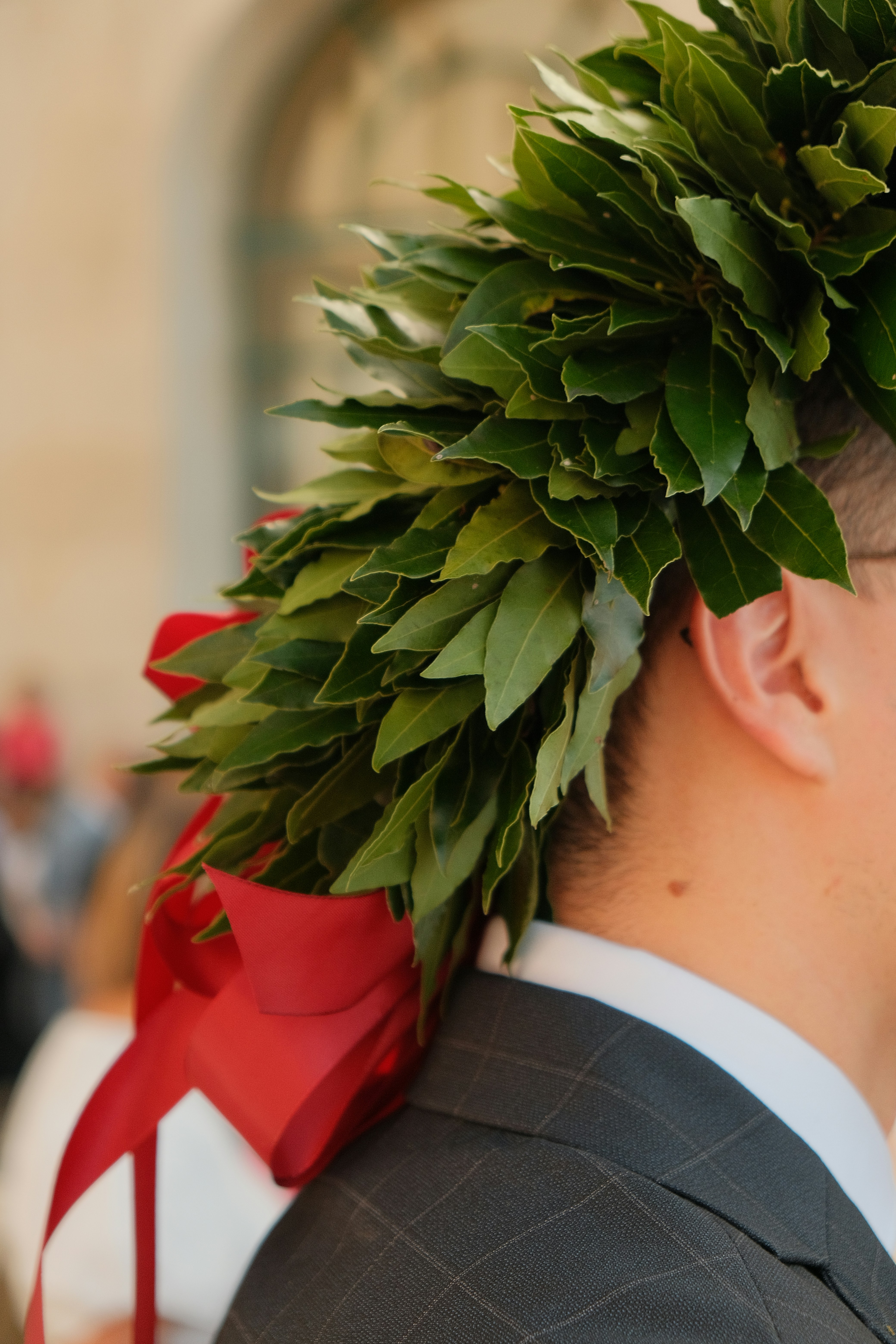Graduation cap with laurel wreath and red ribbon
