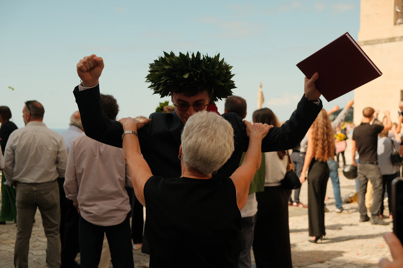 A graduate celebrating a major milestone with family and friends