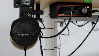 Headphones and audio interface on a desk