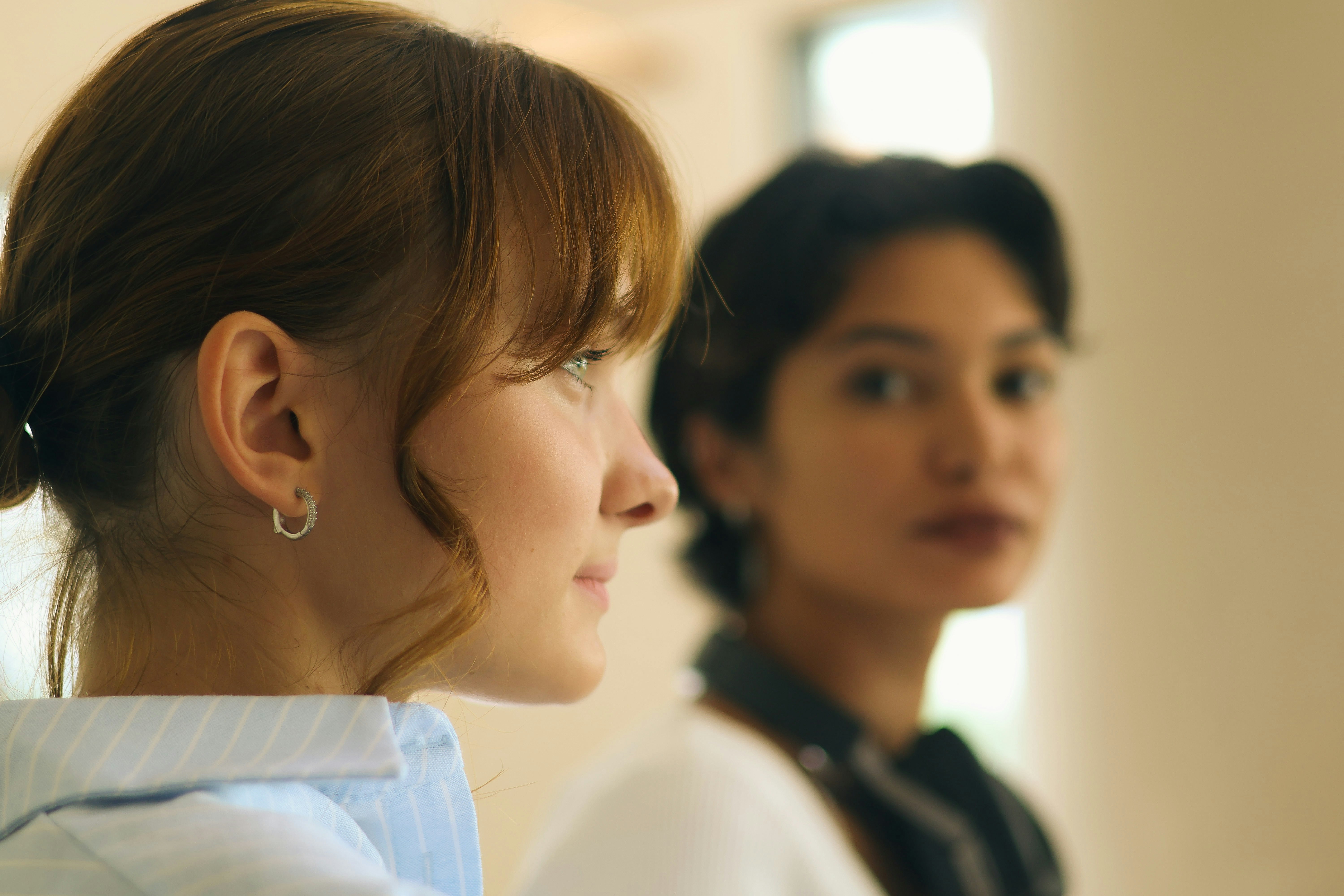 Two women looking in different directions