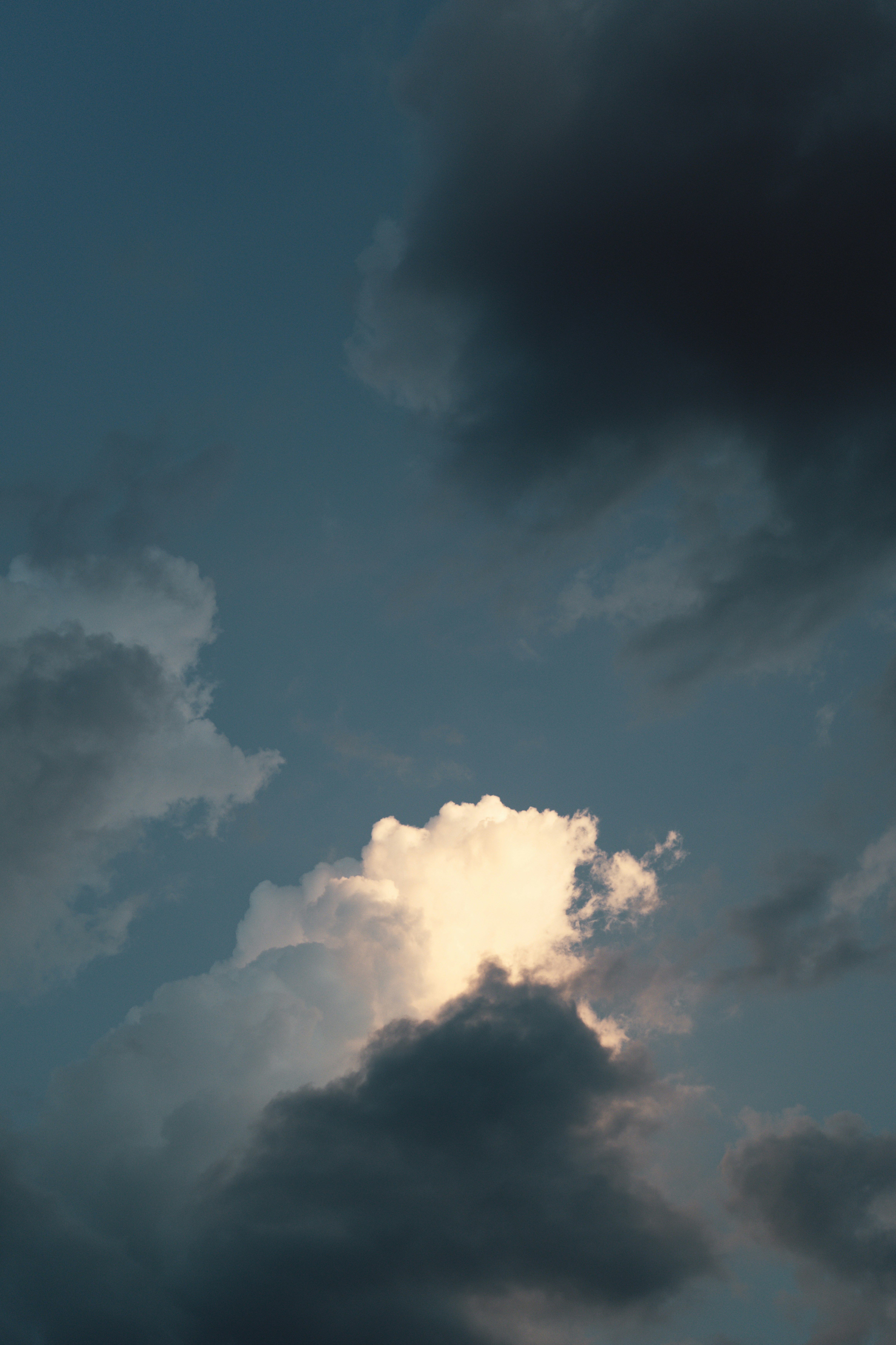 Dramatic clouds illuminated by golden sunset light.