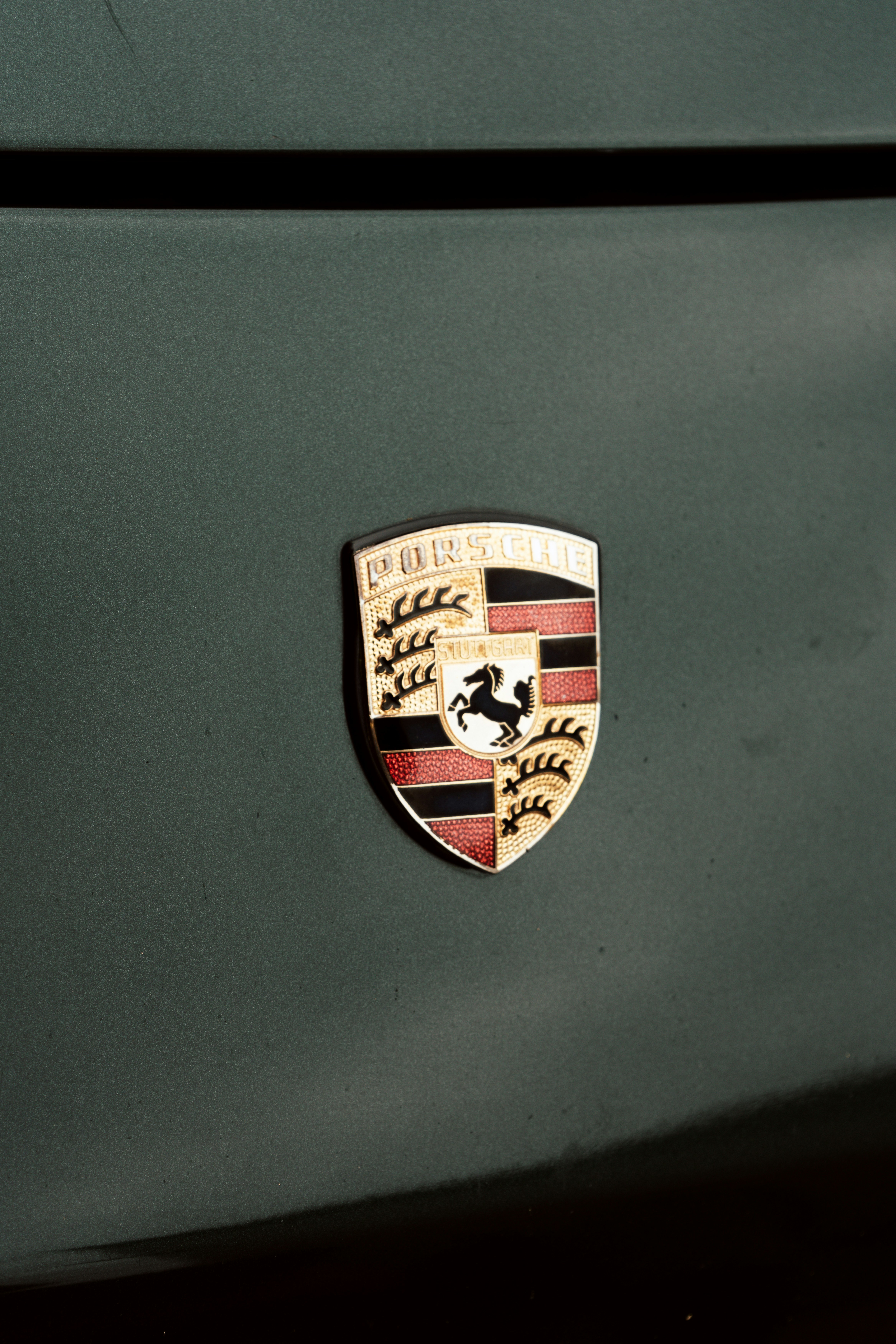 Emblema Porsche su un'auto verde scuro