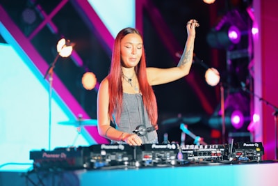 Woman dj performing on stage with turntables