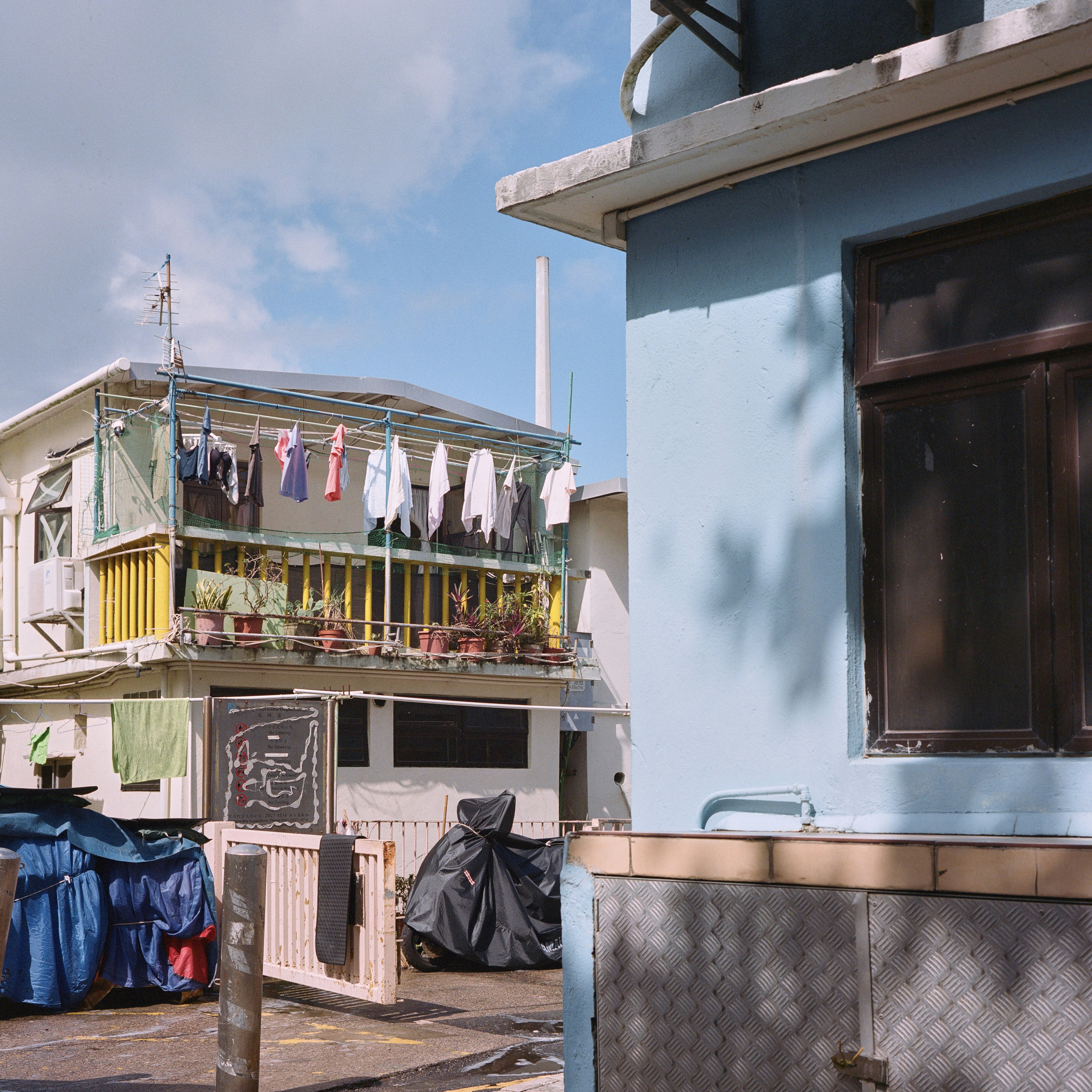 Laundry hanging on balconies of apartment buildings.