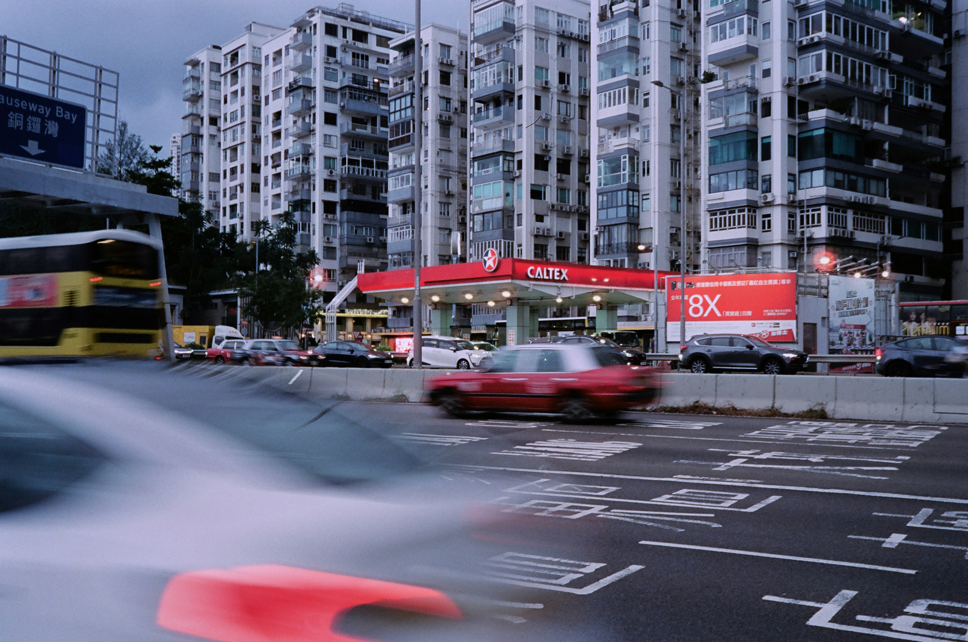 Busy city street with traffic and tall buildings.