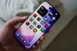 Hand holding a smartphone with colorful app icons