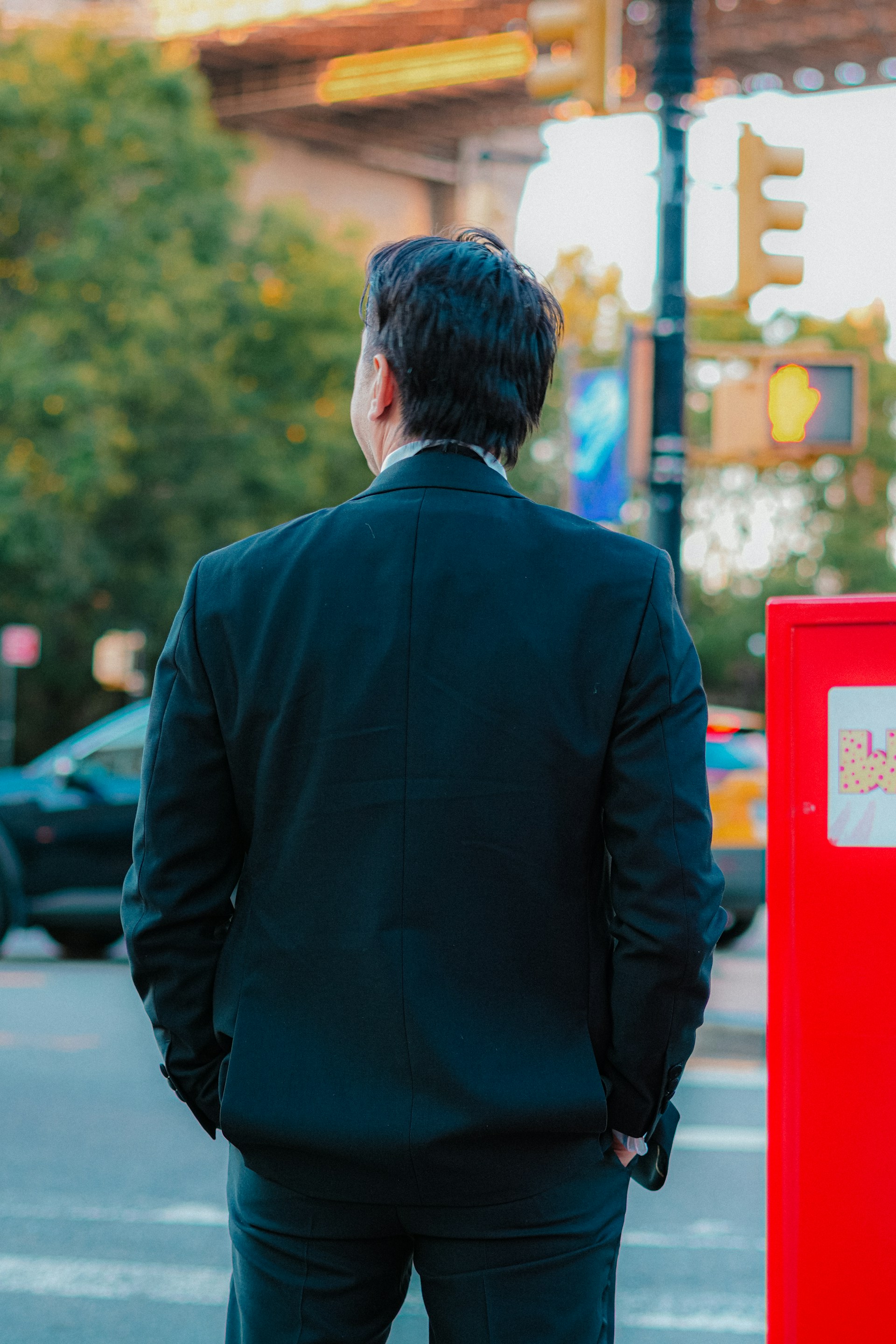 Man in suit looking at city street