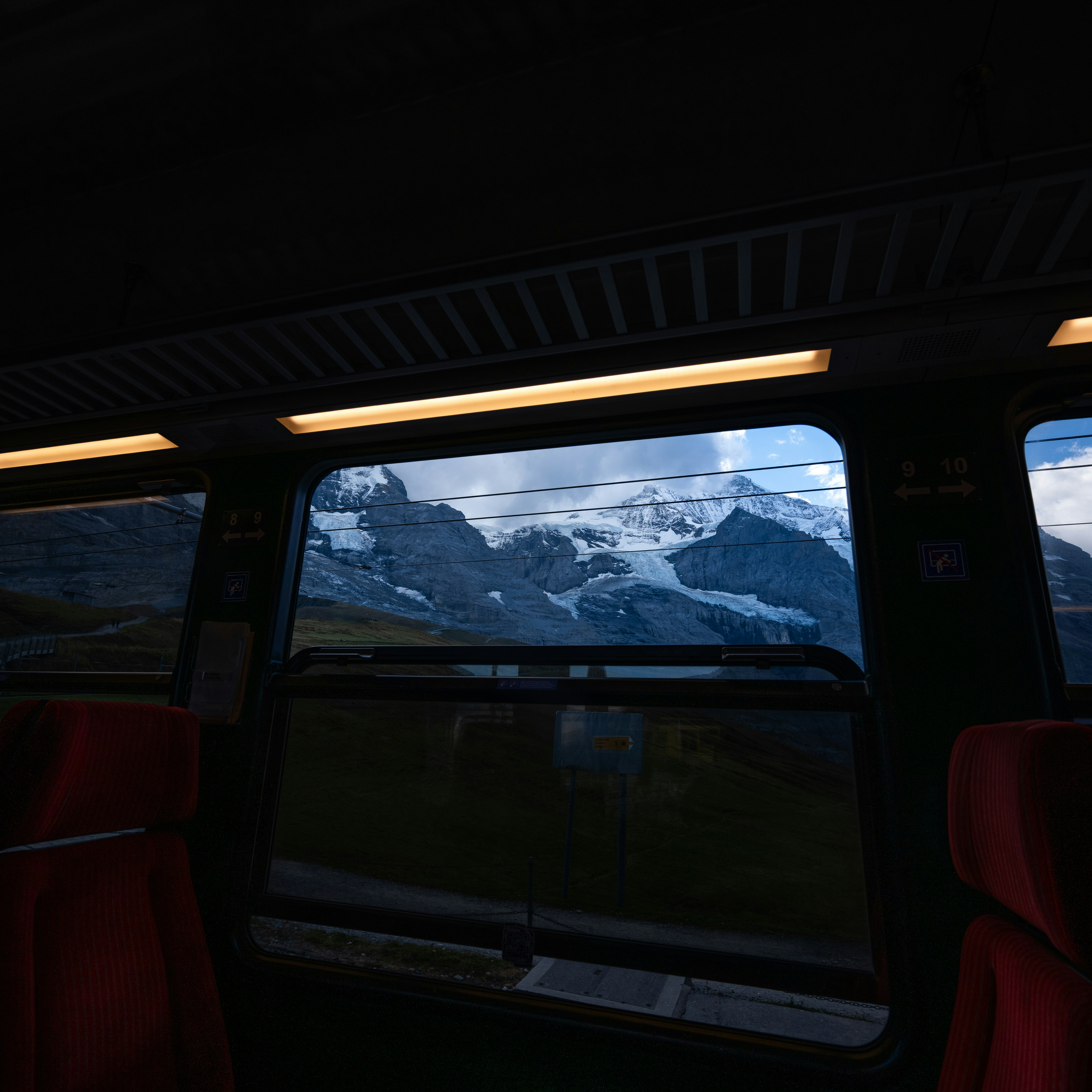 Snow-capped mountains seen through train window