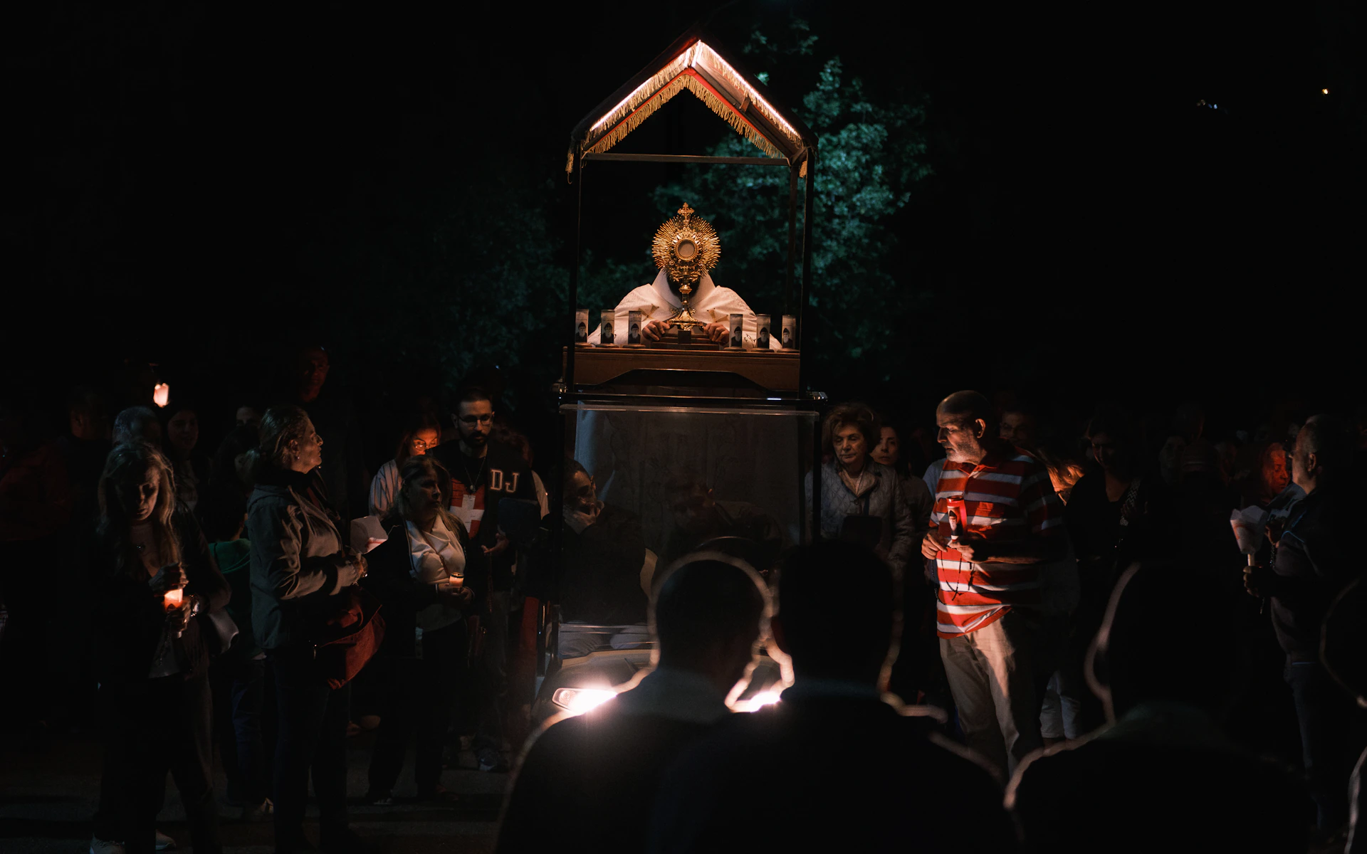People gather around a ritualistic altar at night.