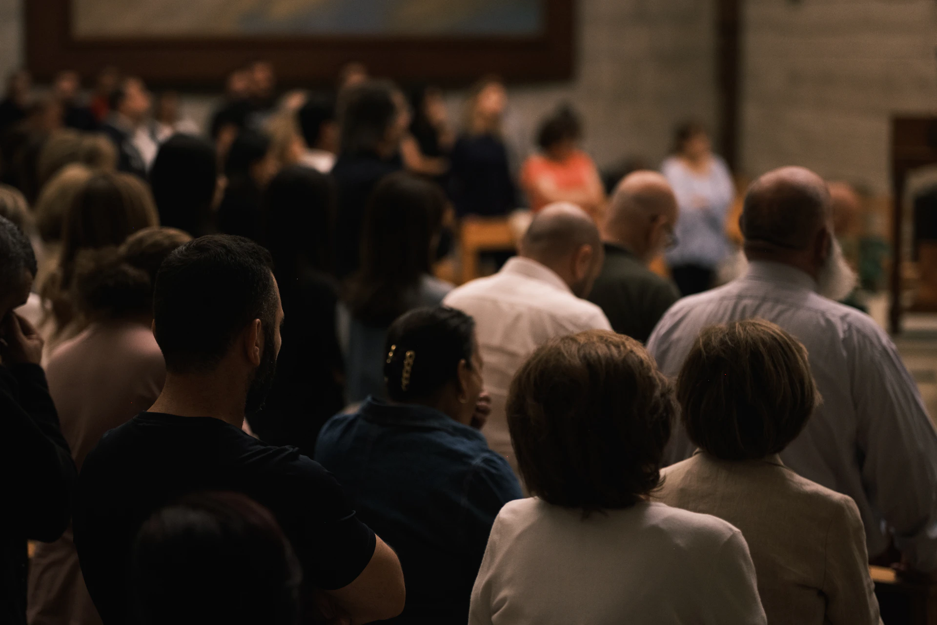 A crowd of people facing away from the camera