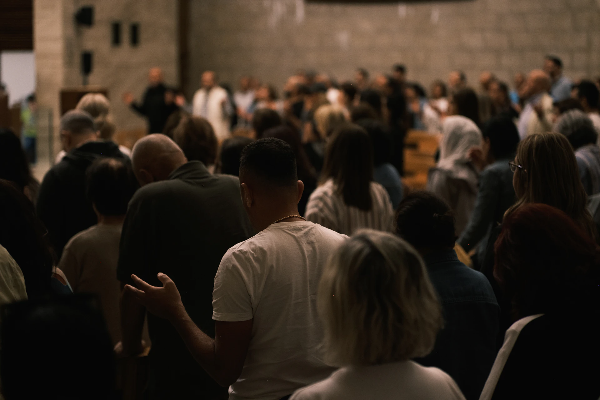 A congregation gathered inside a large hall.