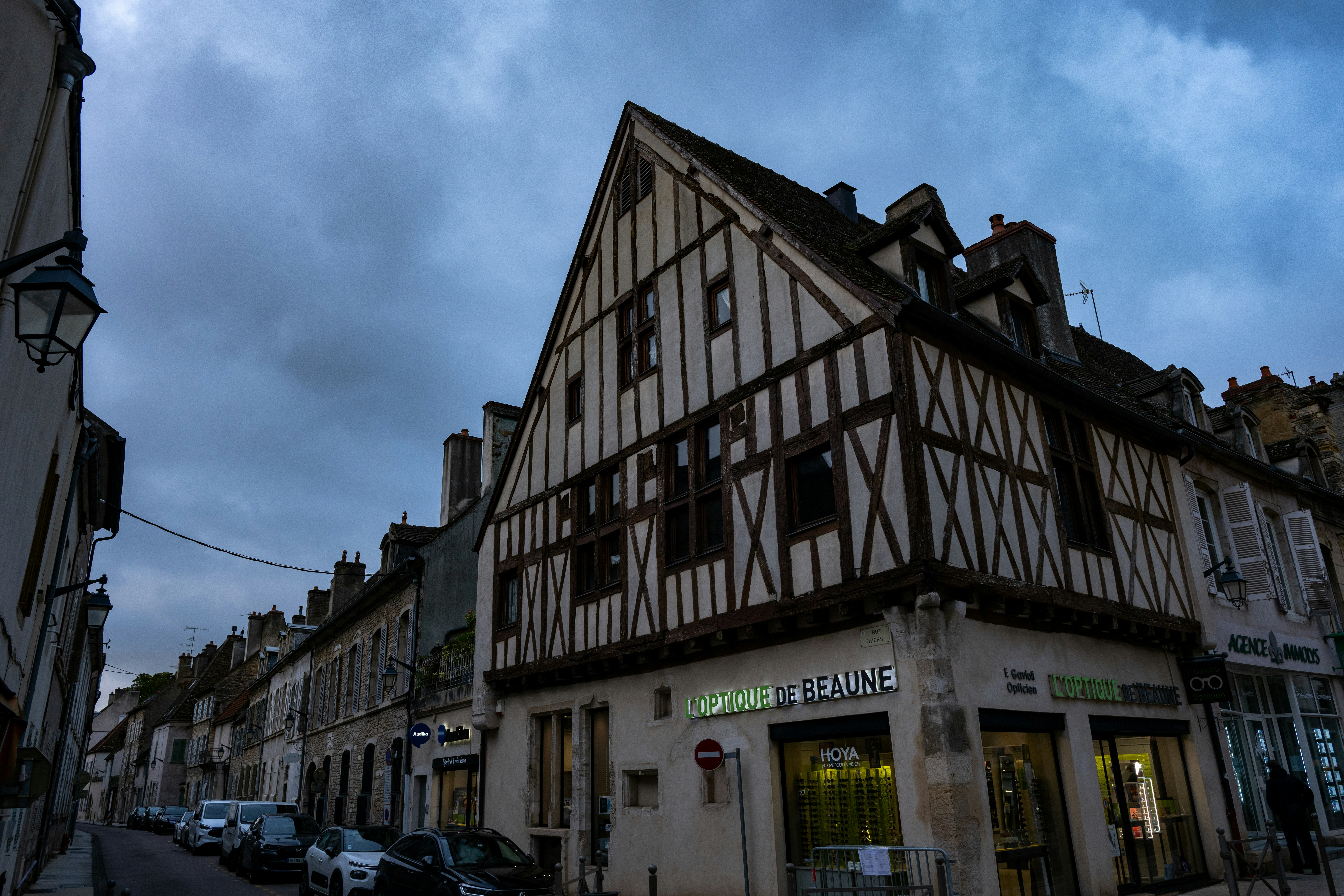 Timber-framed buildings line a european street.