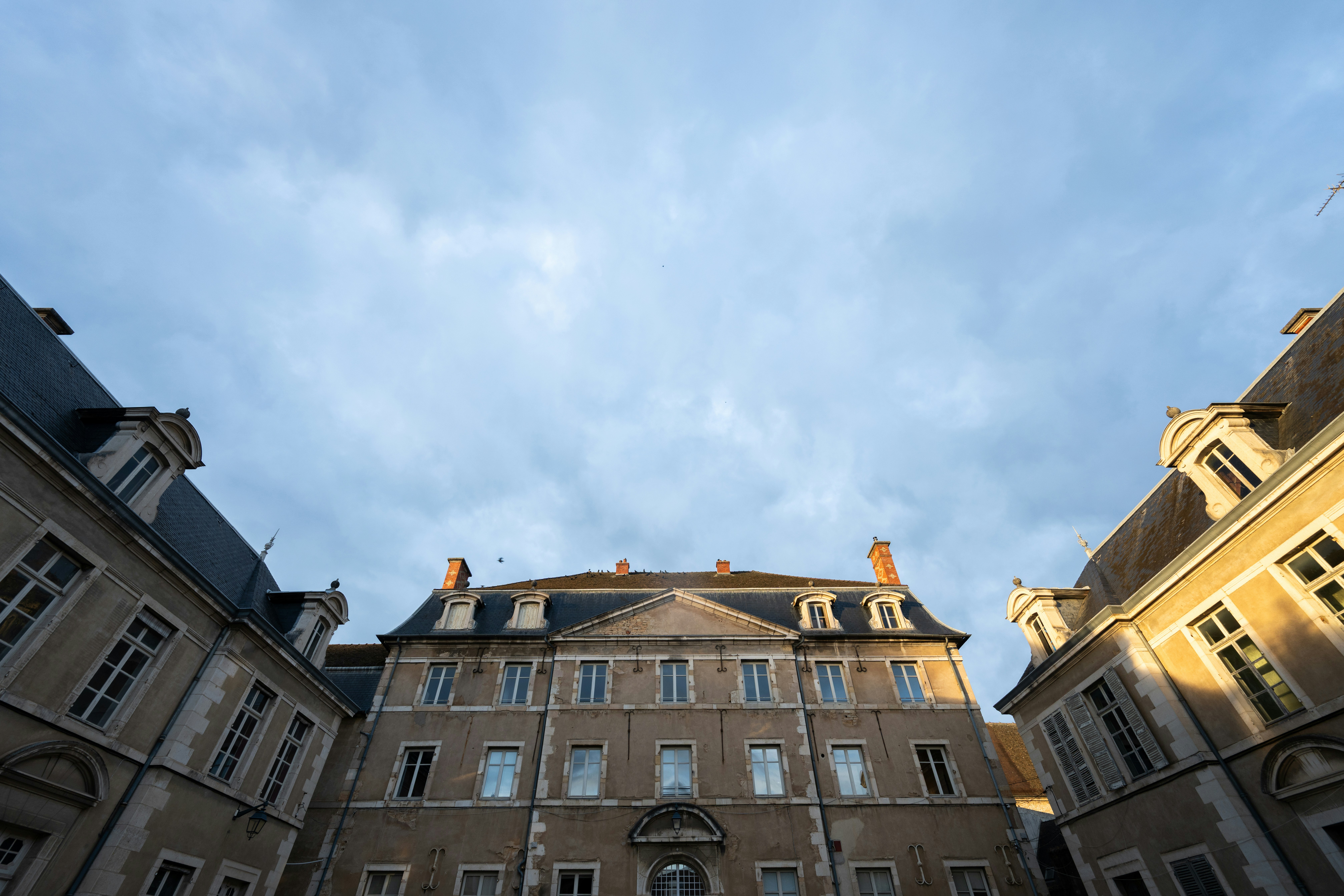 Grand building facade under a cloudy sky