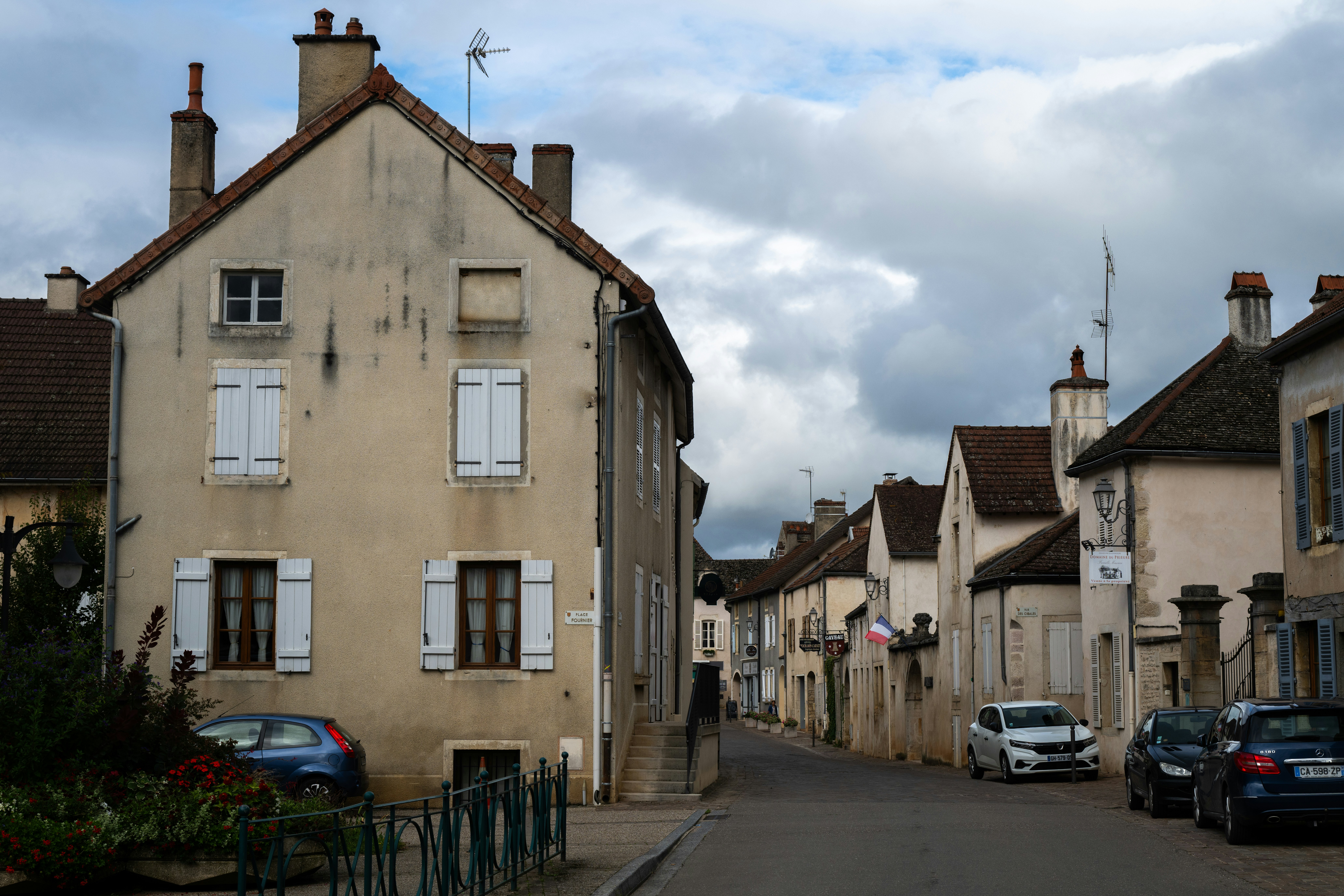 Street scene with old buildings and parked cars
