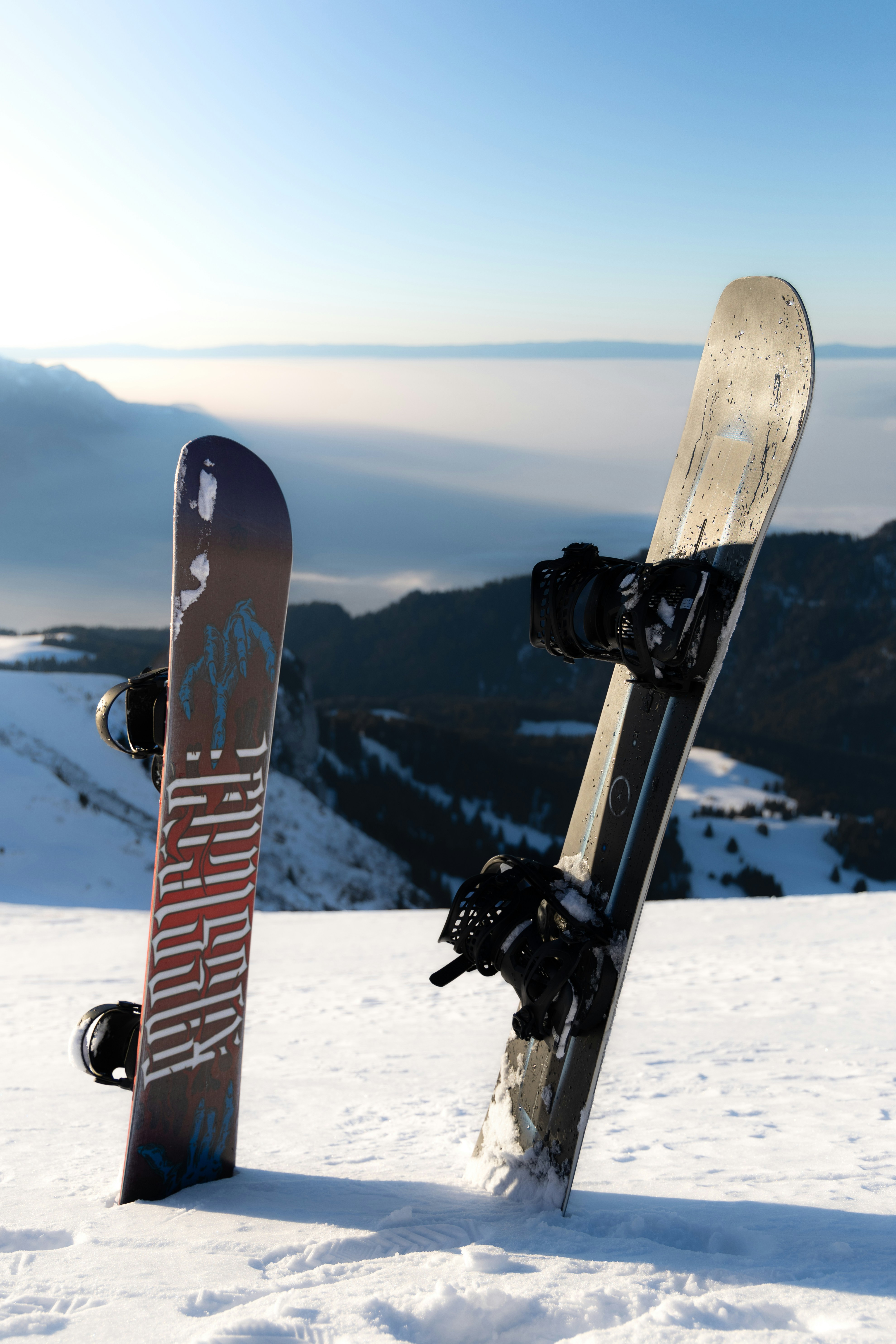 Two snowboards stand in the snow