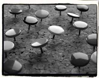 Many thumbtacks on a corkboard