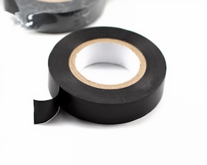 Roll of black electrical tape on white background