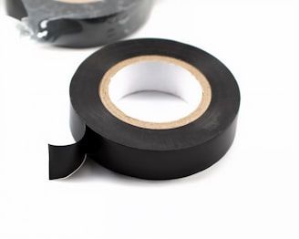 A roll of professional-grade black electrical tape used for securing wire pulling heads.