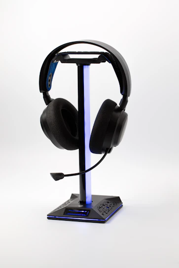 Black gaming headset on a lighted stand