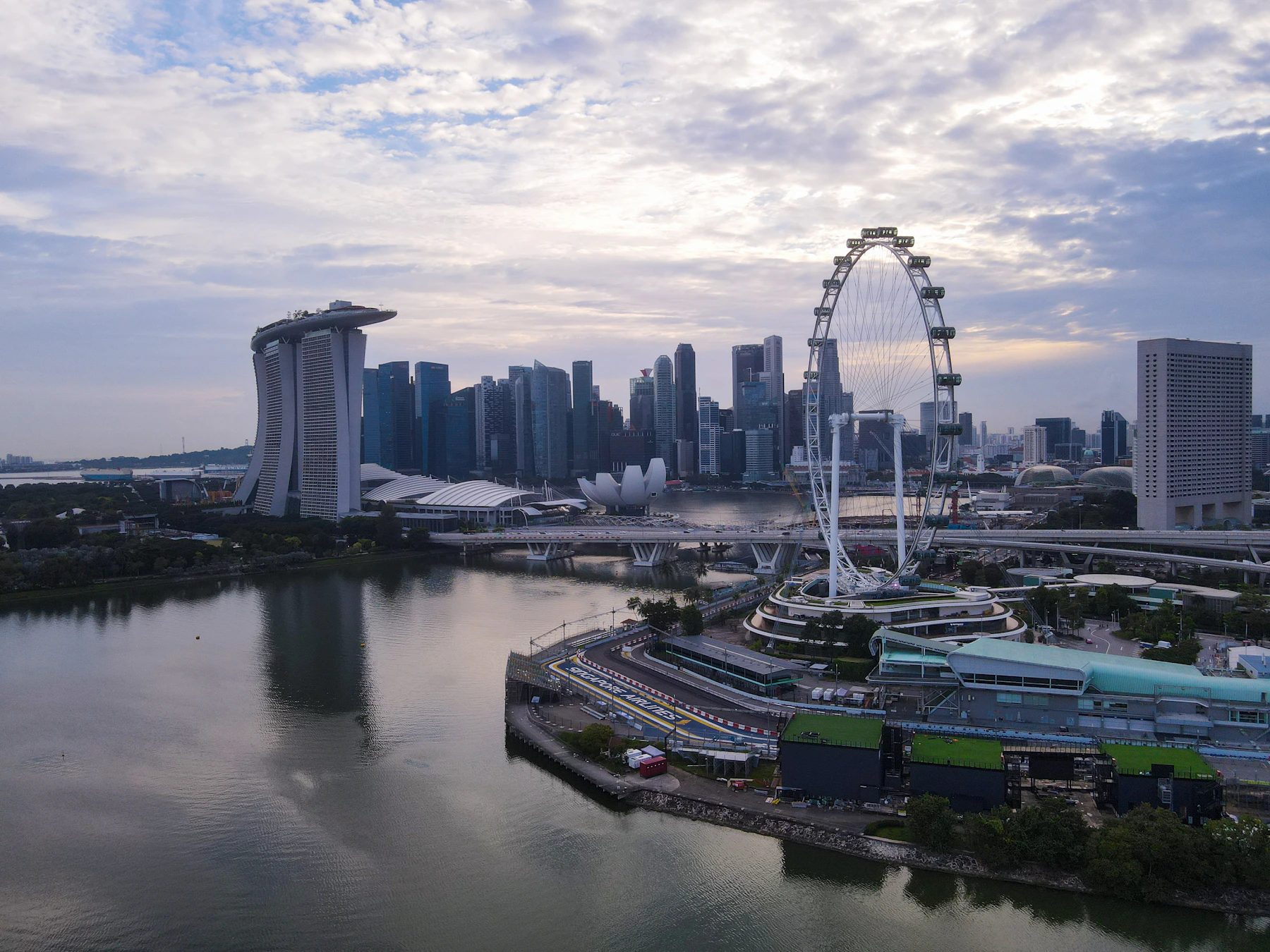 Singapore's Marina Bay skyline and gardens illuminated at dusk