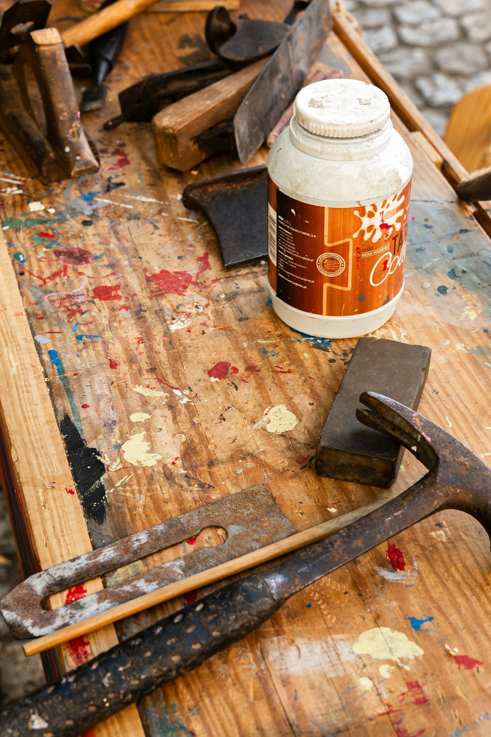 Assortment of old woodworking tools on a stained table.