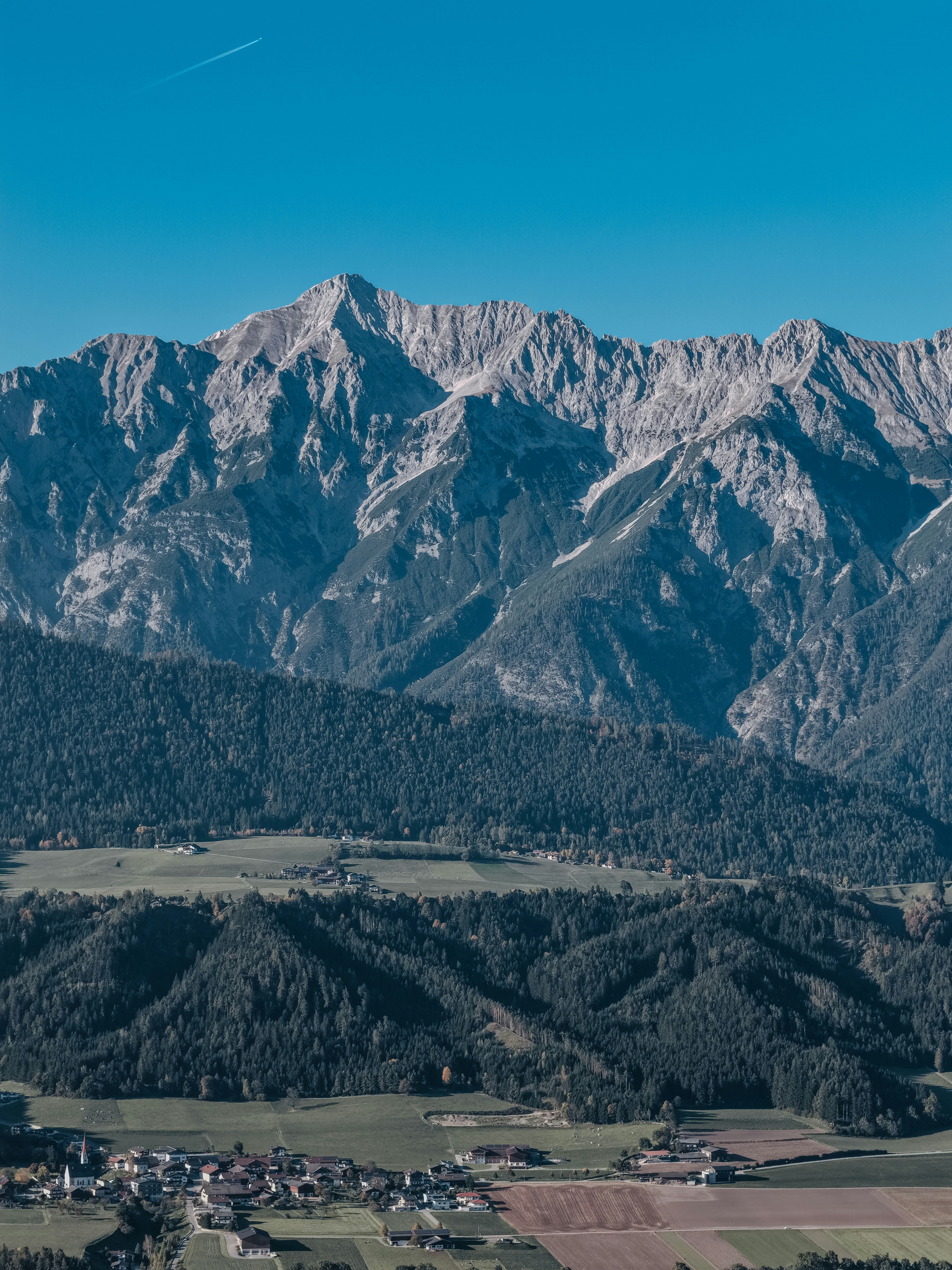 Majestic mountain range overlooks a small village below.