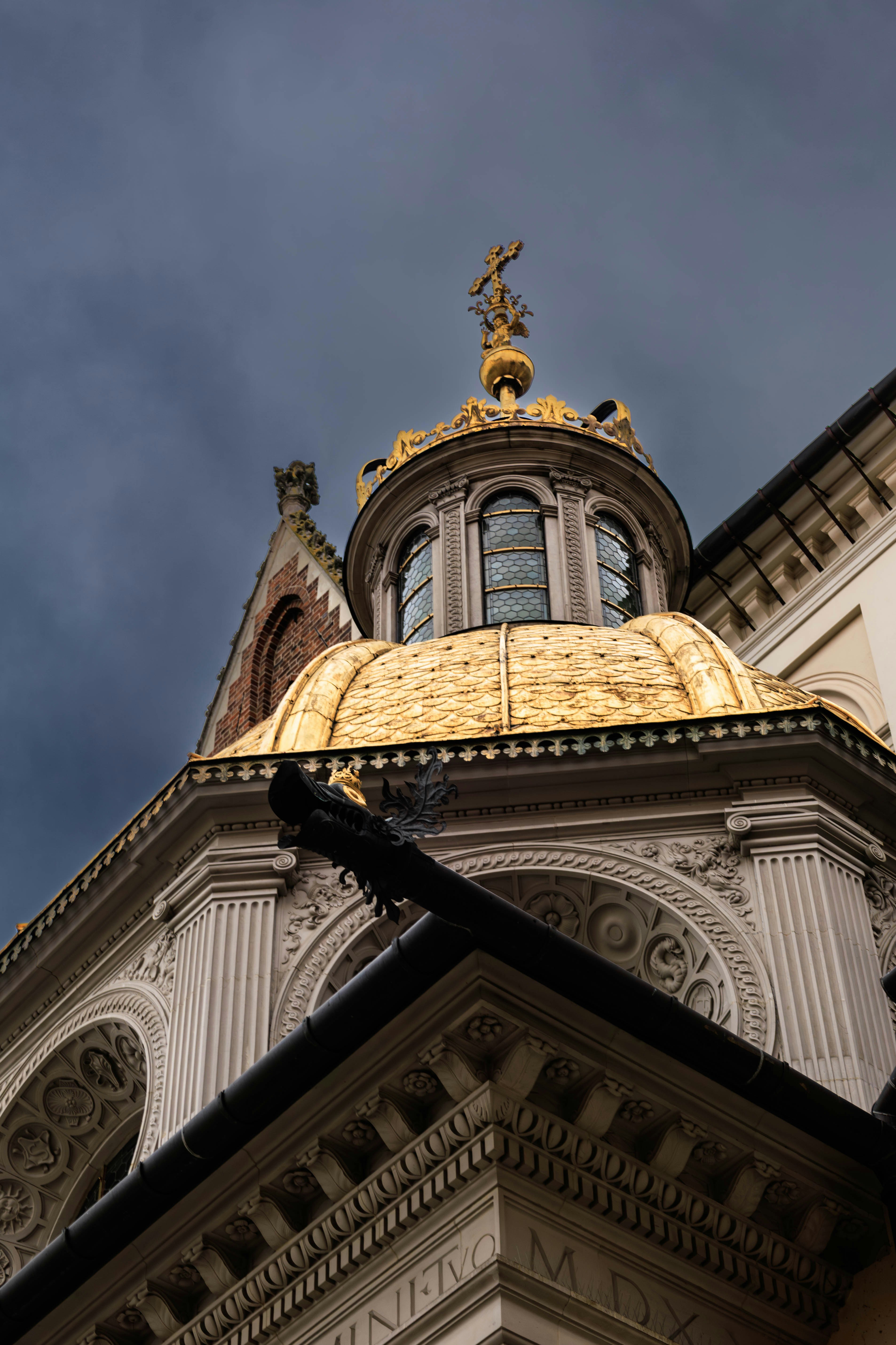 Gilded dome of a historic building against stormy sky