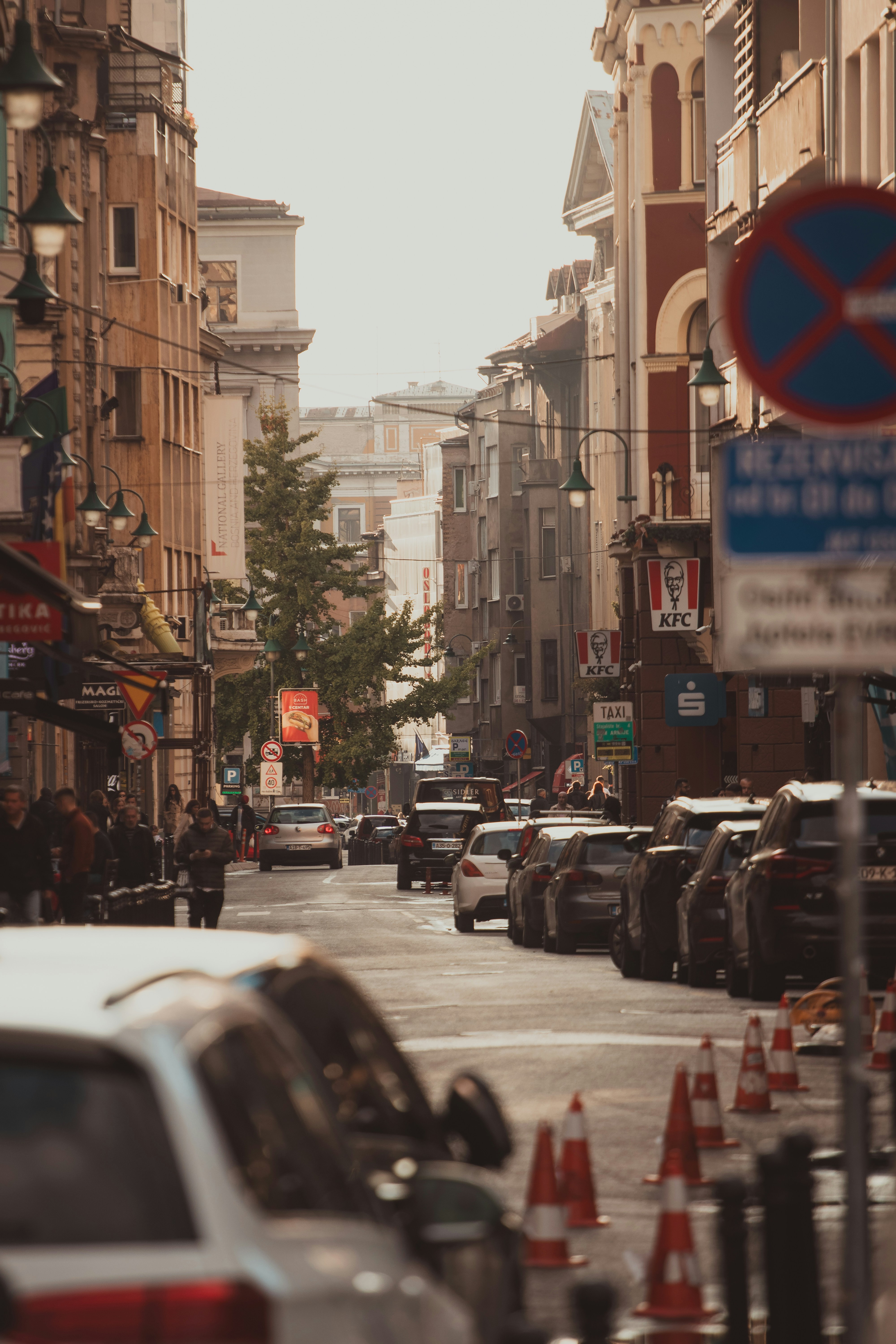 Cars parked on a city street with buildings.