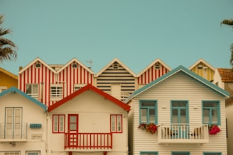 Colorful striped houses against a clear blue sky.