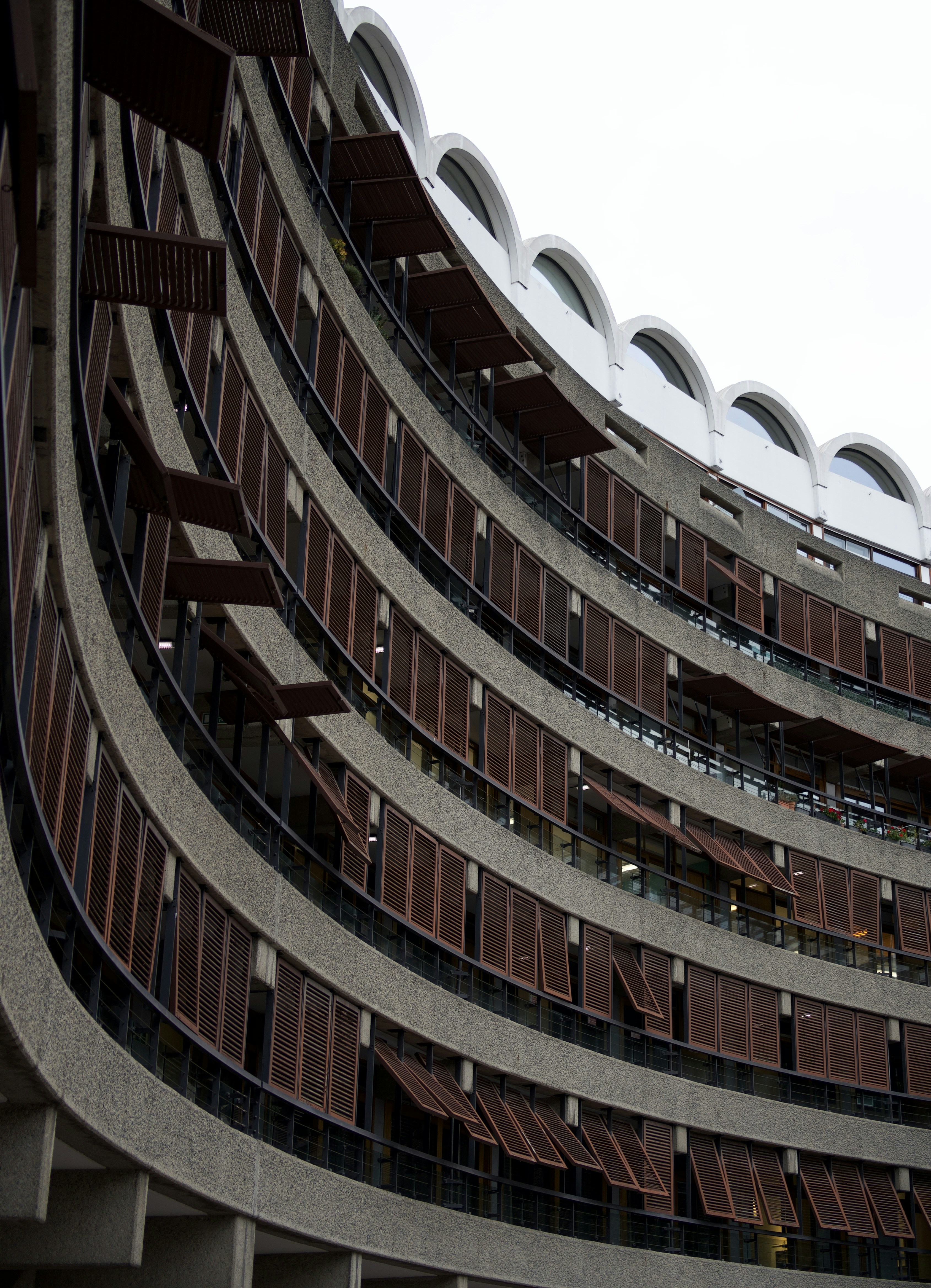 Curved modern building with balconies and windows