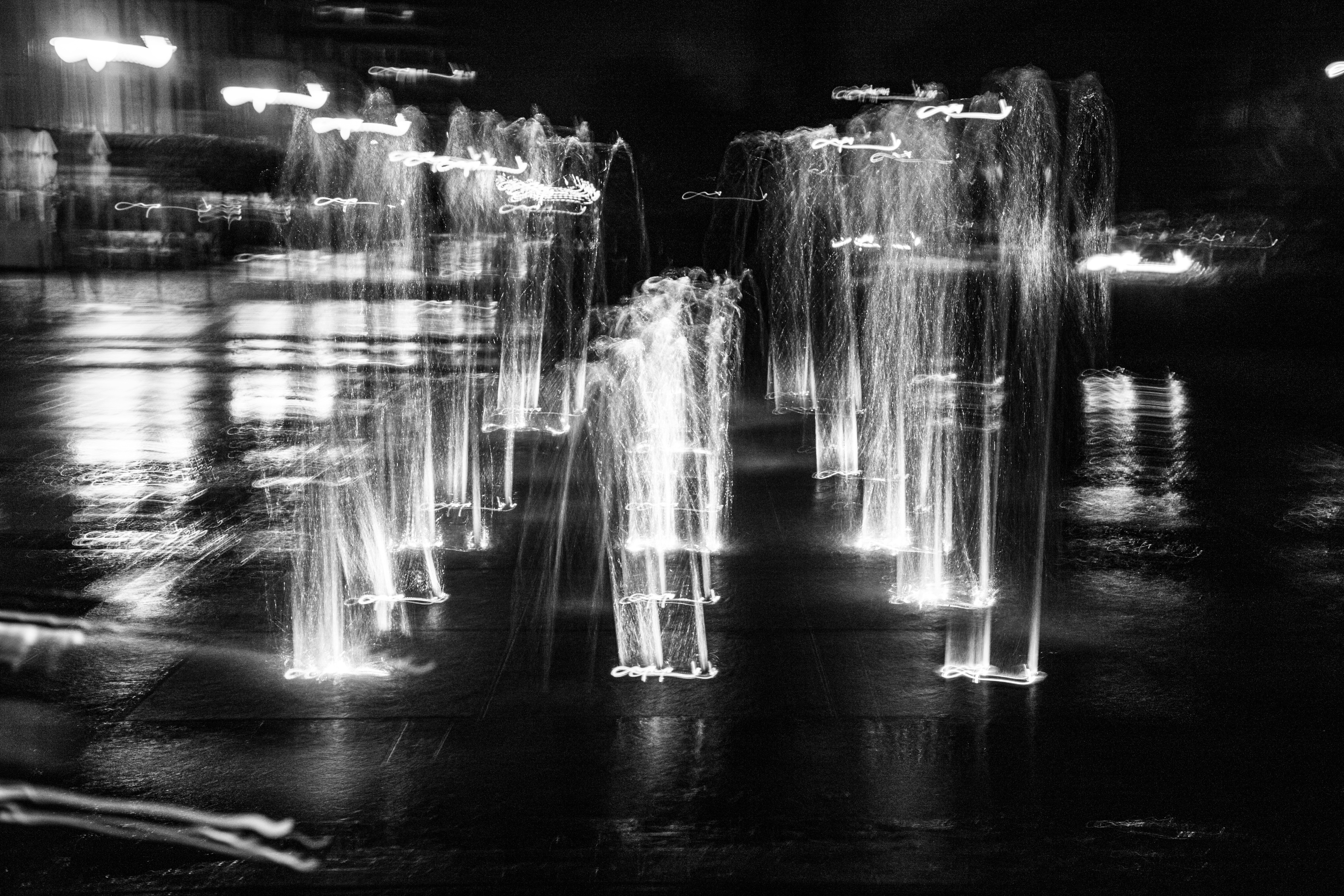 Blurred fountains at night with light trails