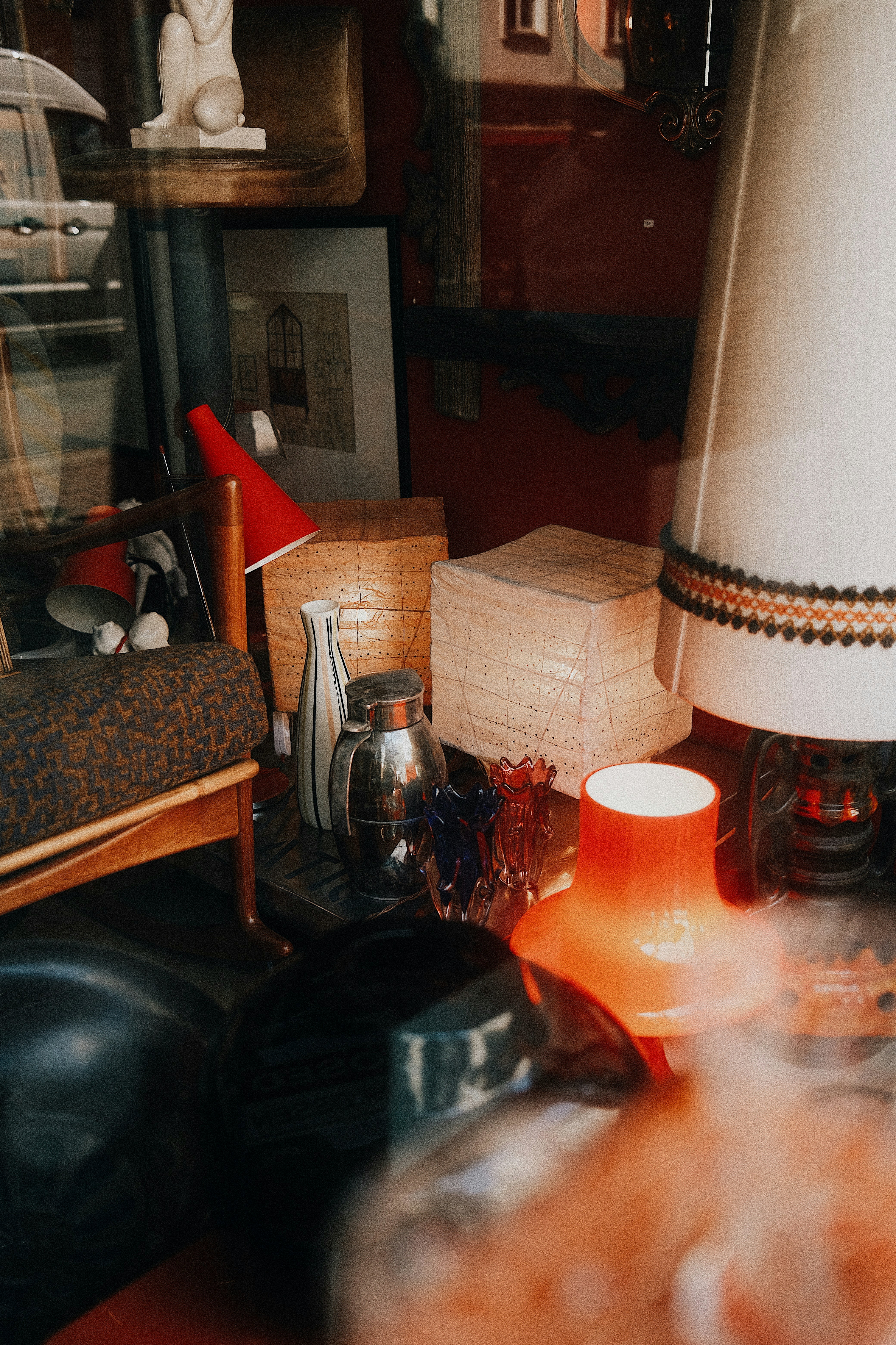 Collection of vintage lamps and decor items on shelf