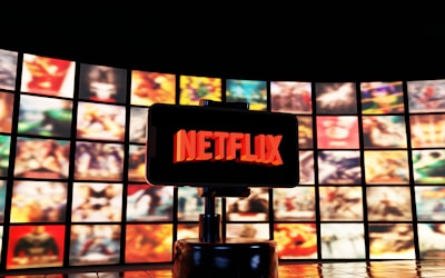 Netflix logo displayed on a screen with movie posters.