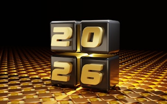 Golden year 2026 illuminated on black cubes