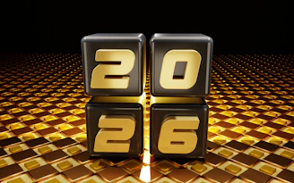 Four cubes displaying the numbers 2026