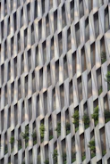 Modern building facade with repeating geometric window patterns.