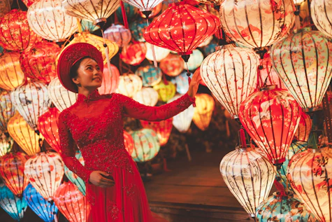 Woman in red dress surrounded by colorful lanterns