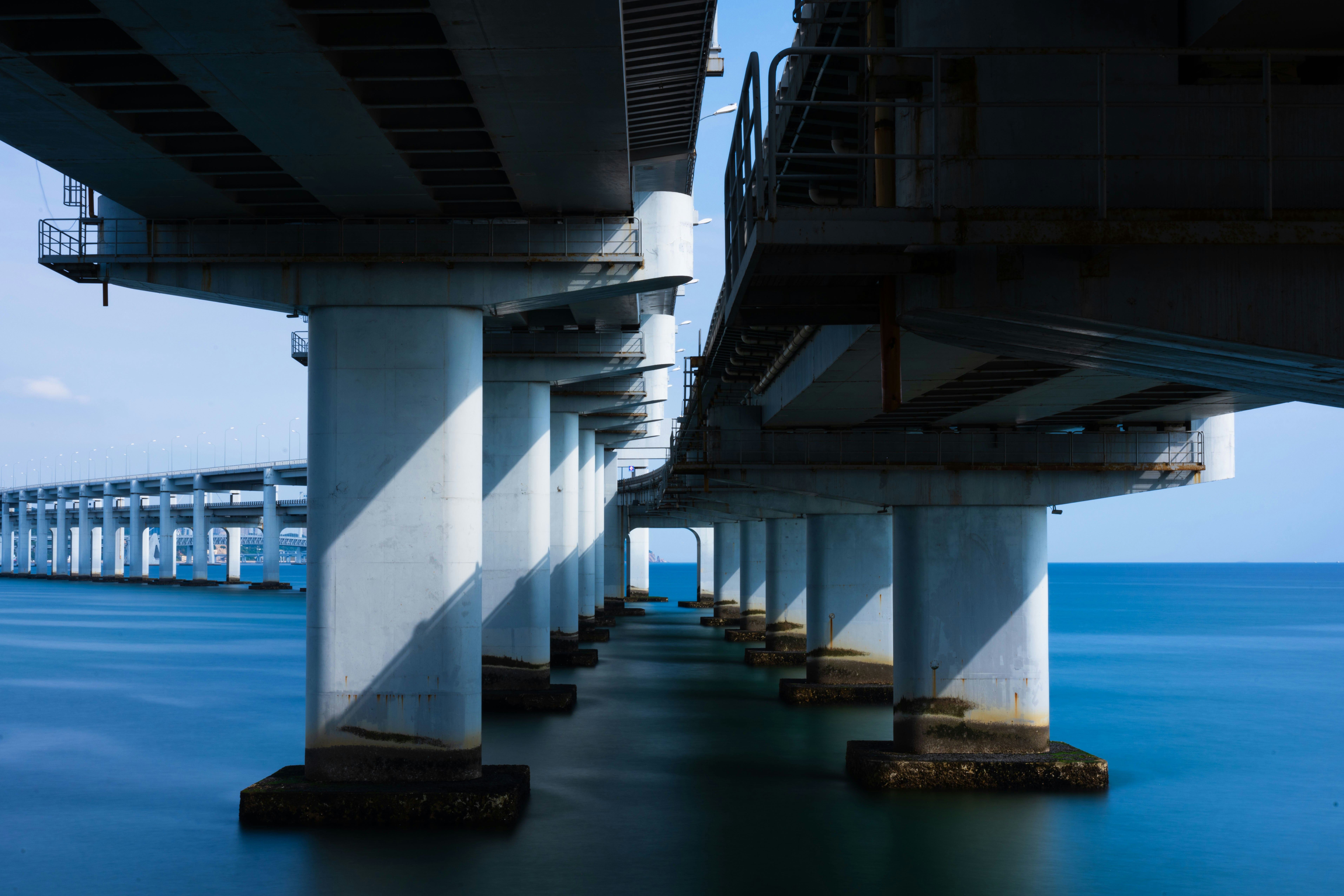 Concrete bridge pillars over ocean