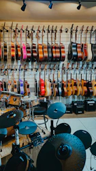 Guitars and drums displayed in a music store.