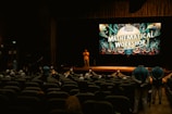 Speaker on stage at a "mathematical workshop" event.