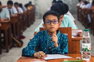 Young boy wearing glasses takes a test