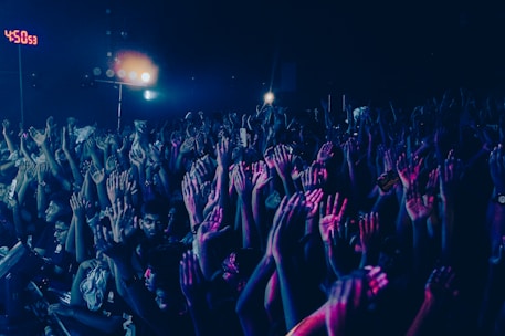 Crowd with hands raised at a night event